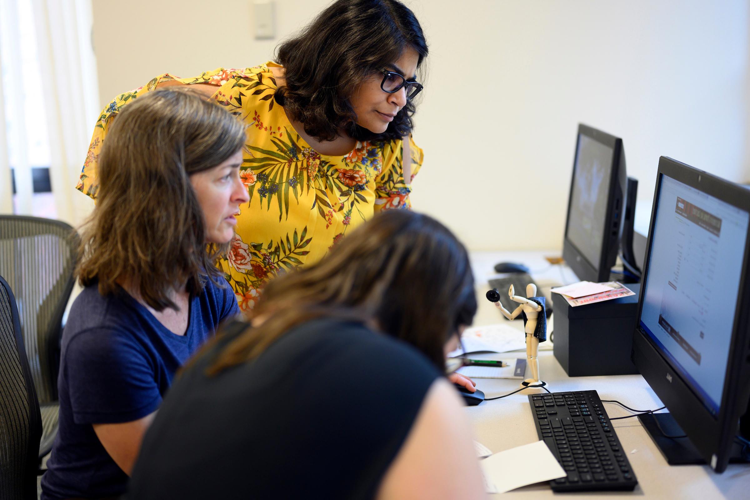 Faculty and staff volunteers test a game for new students